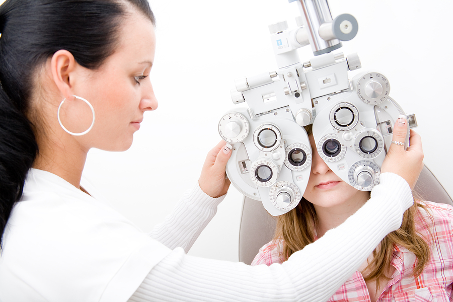 optometrist giving a child an eye exam
